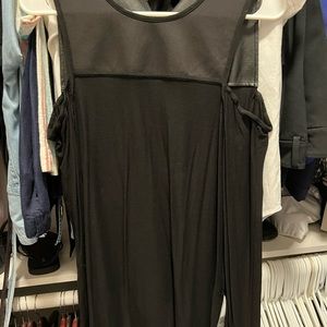 Black blouse with open shoulders, leather.